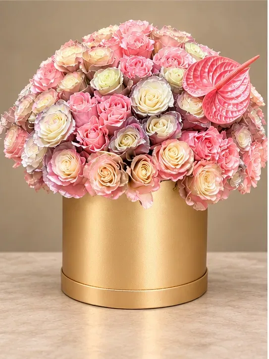 Blush and ivory roses in a gold vase